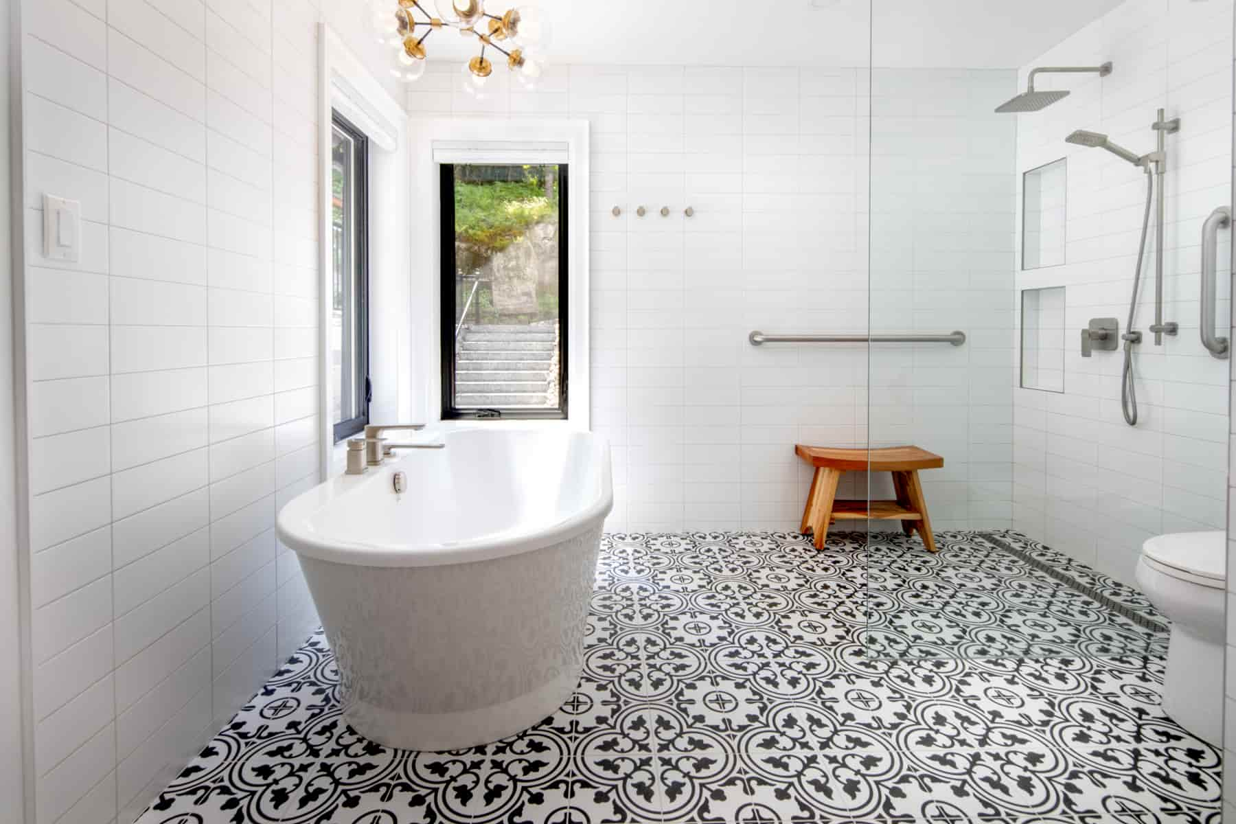 Modern bathroom with a striking black and white tile floor, found in Lake Muskoka, created by Ballantyne Builds.