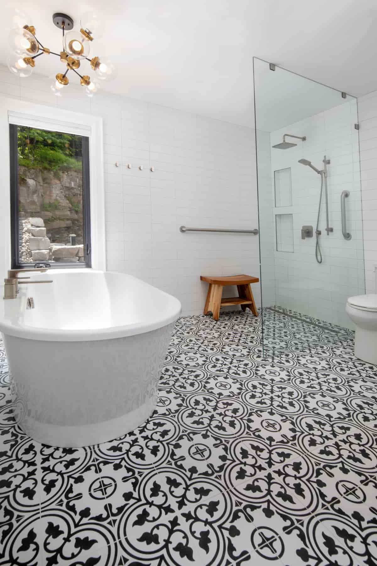  Modern bathroom with a striking black and white tile floor, found in Lake Muskoka, created by Ballantyne Builds.