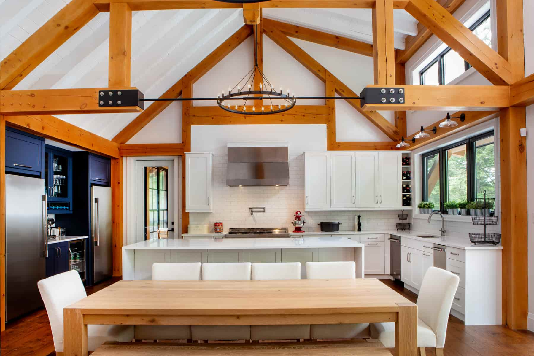 A stylish kitchen showcasing wooden beams and a dining table, created by Lake Muskoka Ballantyne Builds.