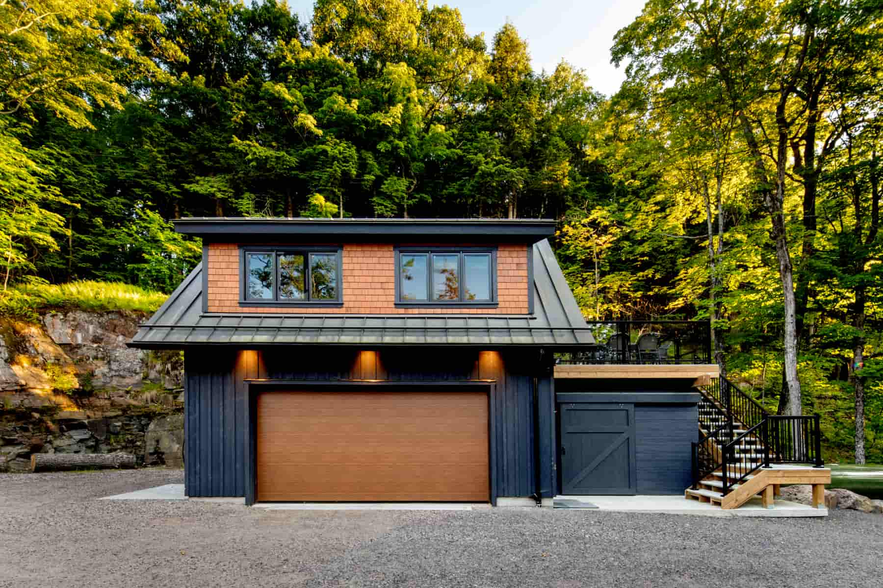 Modern garage design with a wooden deck and door, located by Lake Muskoka, crafted by Ballantyne Builds.
