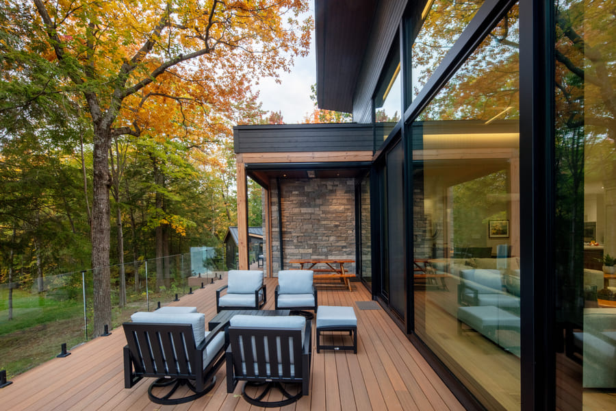 Side Deck View with Stone Features with Dark Exterior | Ballantyne Builds