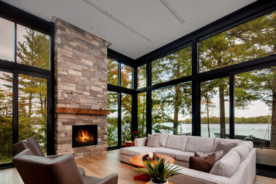 Two Full Glass Walls with Stone Fireplace | Ballantyne Builds