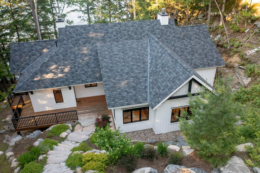 ariel photo of exterior of white and grey custom cottage | Ballantyne Builds