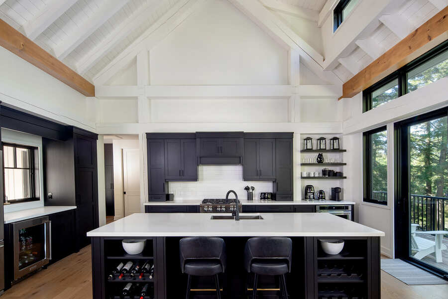 beautiful kitchen with white countertops and black cabnites, large kitchen island | Ballantyne Builds