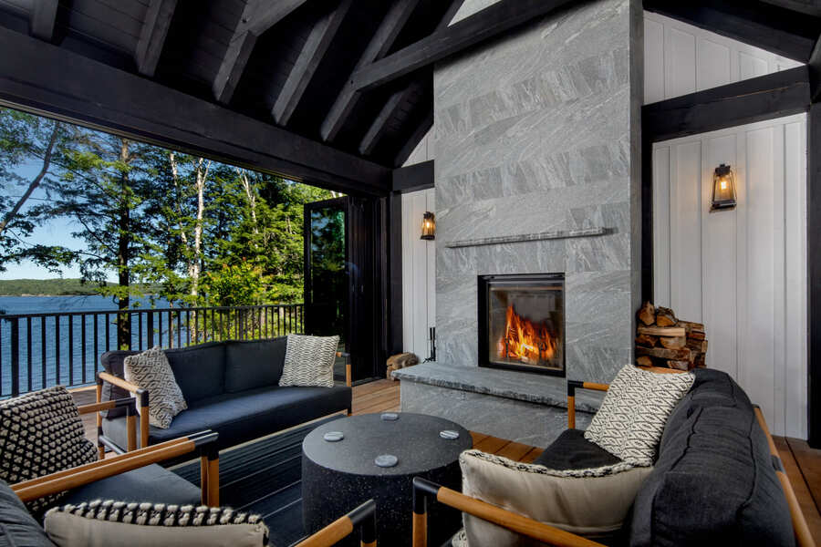 outdoor patio, deck with large stone built in fireplace, wooden bean ceiling | Ballantyne Builds