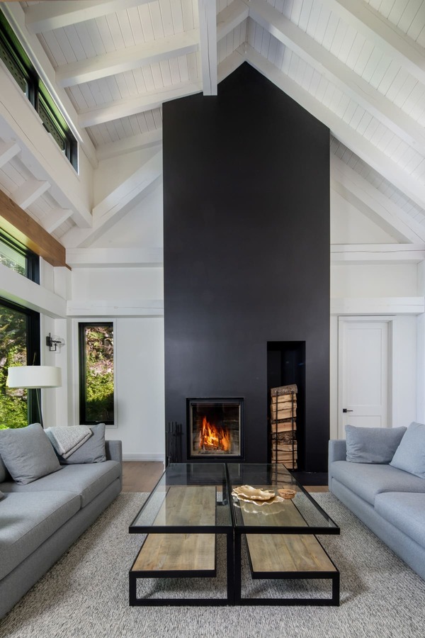 tall black fireplace with built in wood storage | Ballantyne Builds