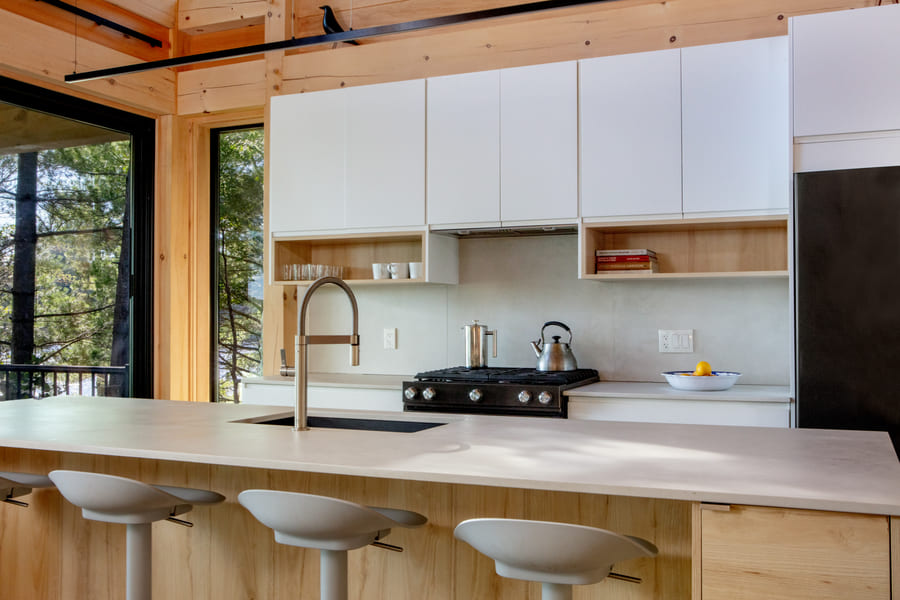 cottage kitchen with large kitchen island, white cabnites, modern appliances, large kitchen windows | Ballantyne Builds