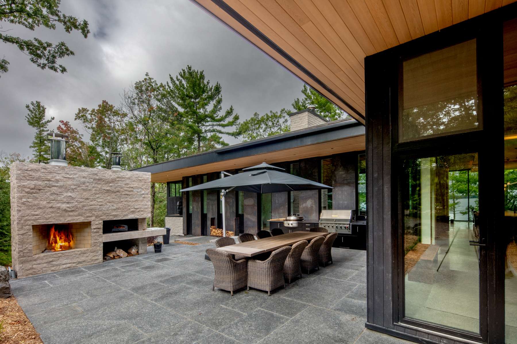 Outdoor area with fireplace in Georgian Bay | Ballantyne Builds
