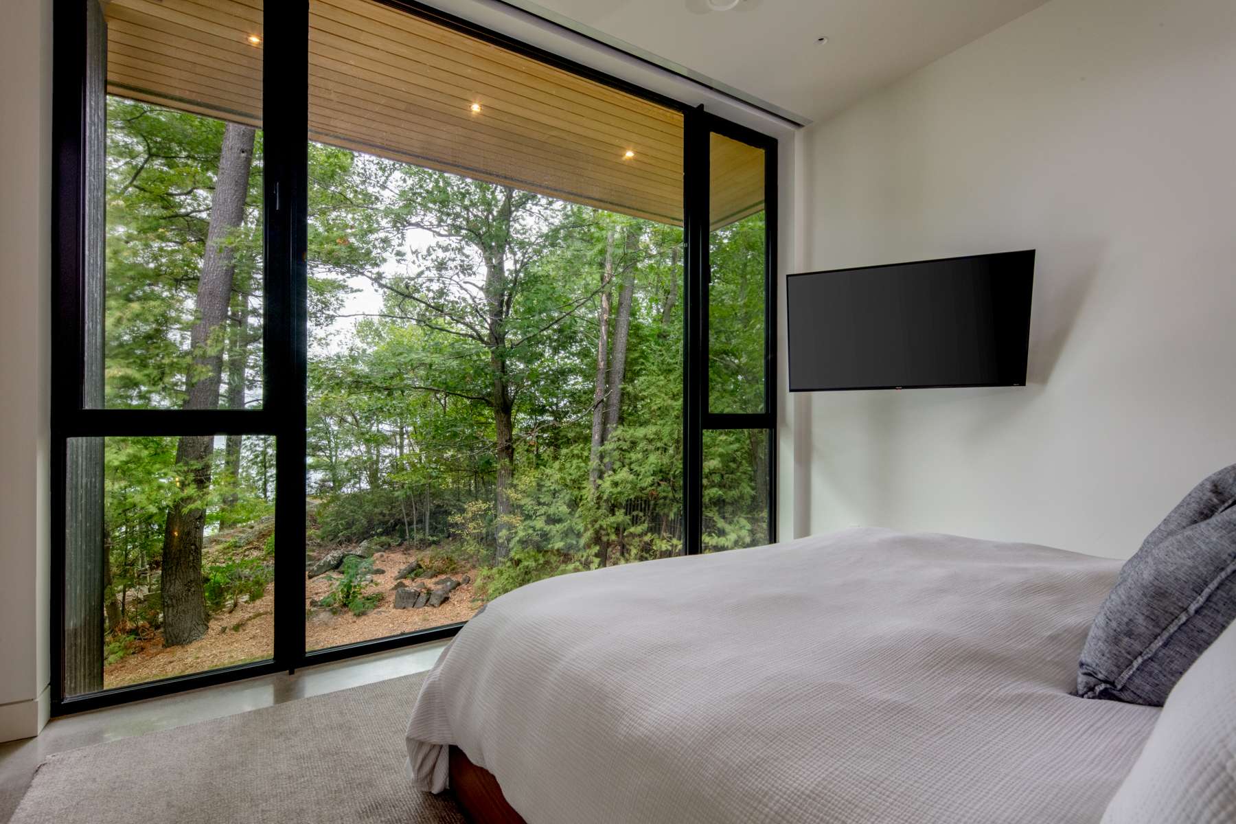 Bedroom with floor to ceiling windows | Ballantyne Builds